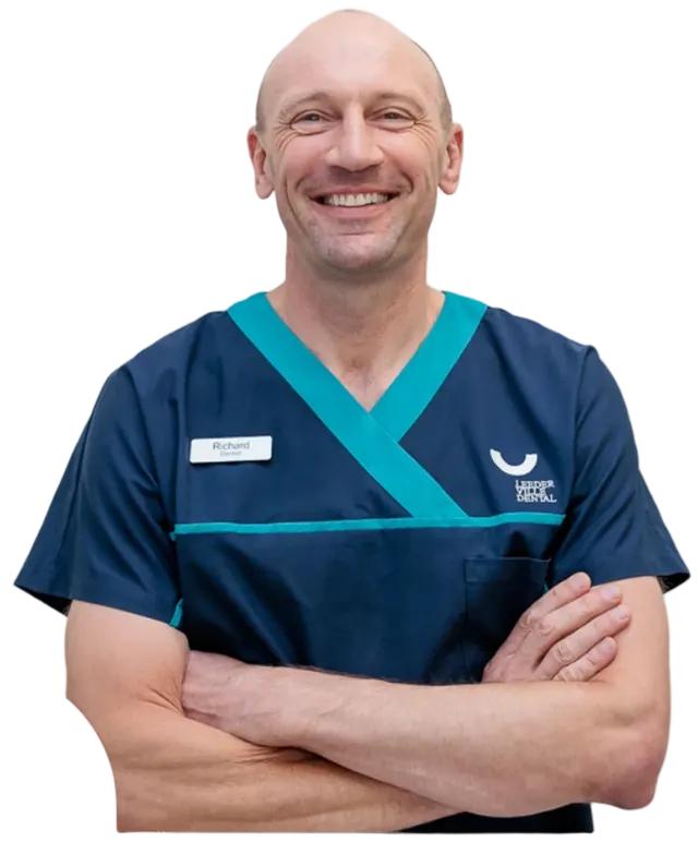 Dr Richard Kozlowski, principal dentist at Leederville Dental, smiling with arms crossed
